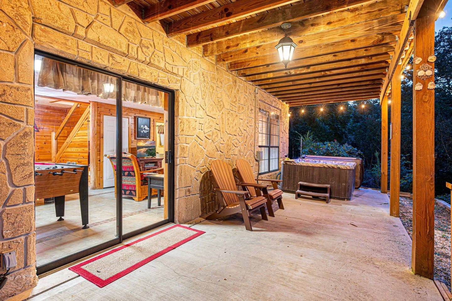 The covered lower porch just outside the game room, with the hot tub a few steps away.