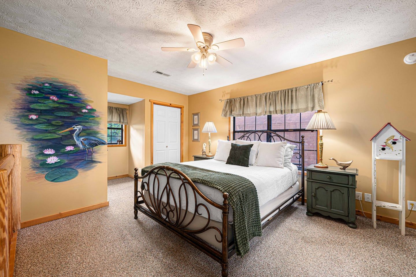 The loft sleeps two in a queen bed, open to the main living space below.