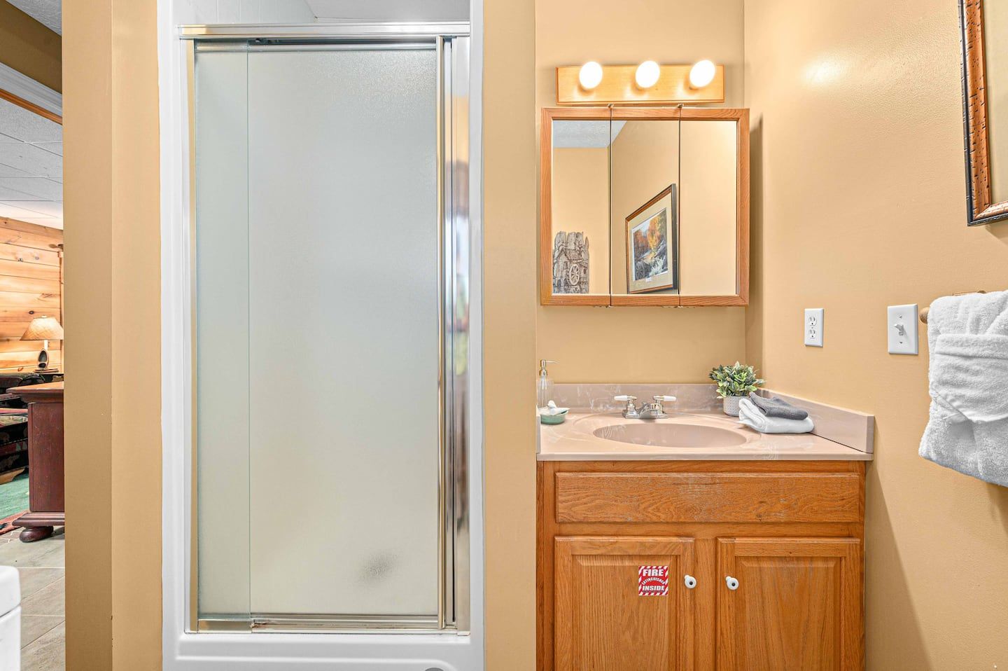 The basement full bathroom with a walk-in shower, next to the game room and the laundry.