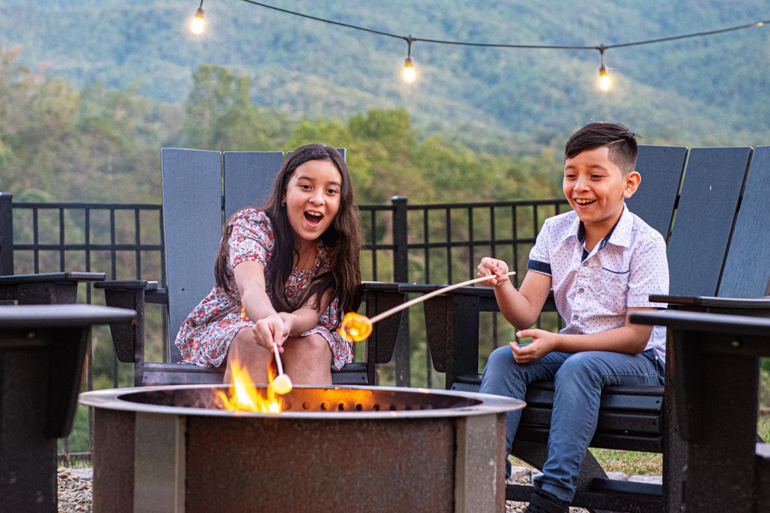 Kids toasting marshmallows at the fire pit