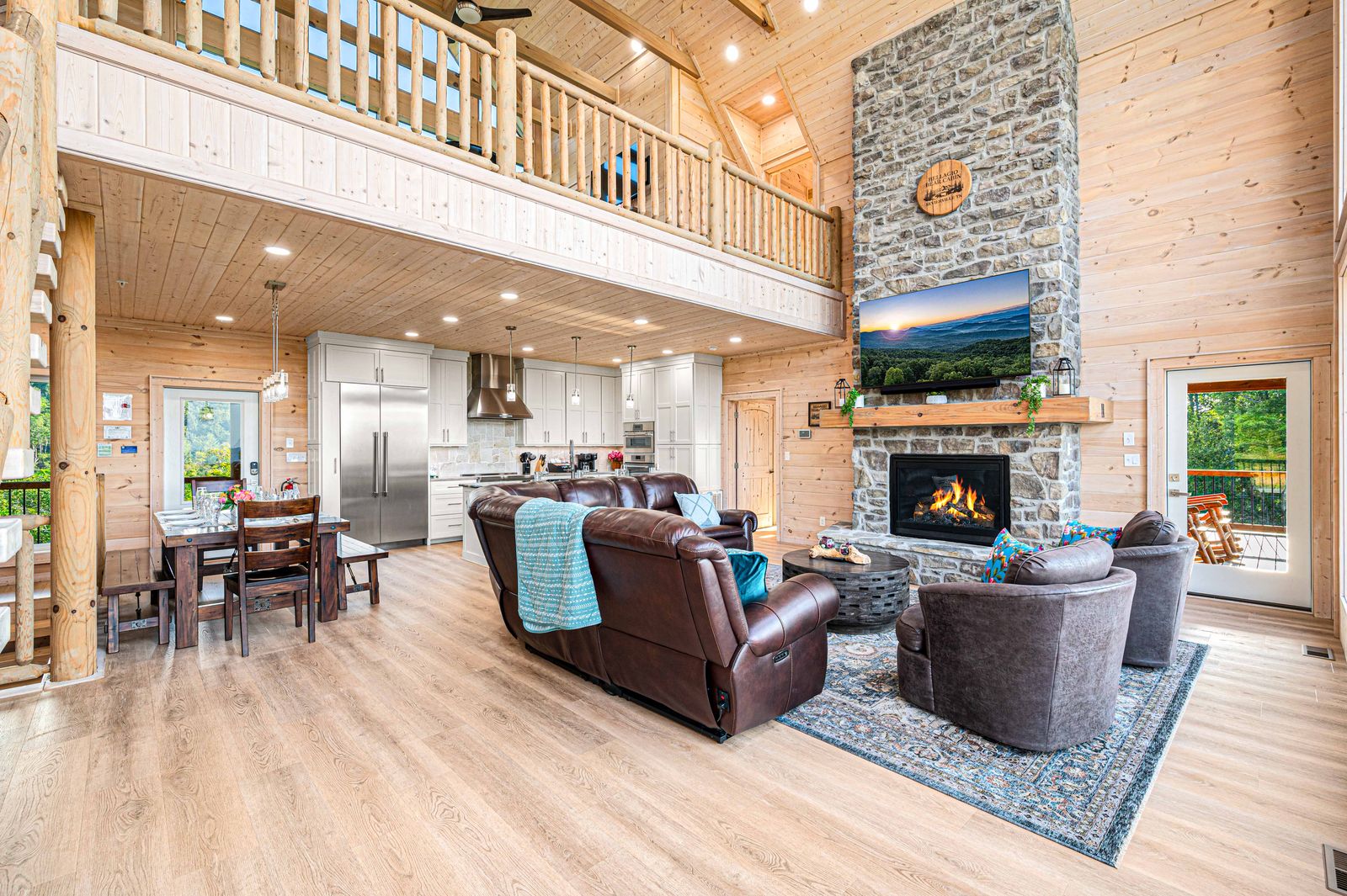 Great room with stone fireplace and open kitchen
