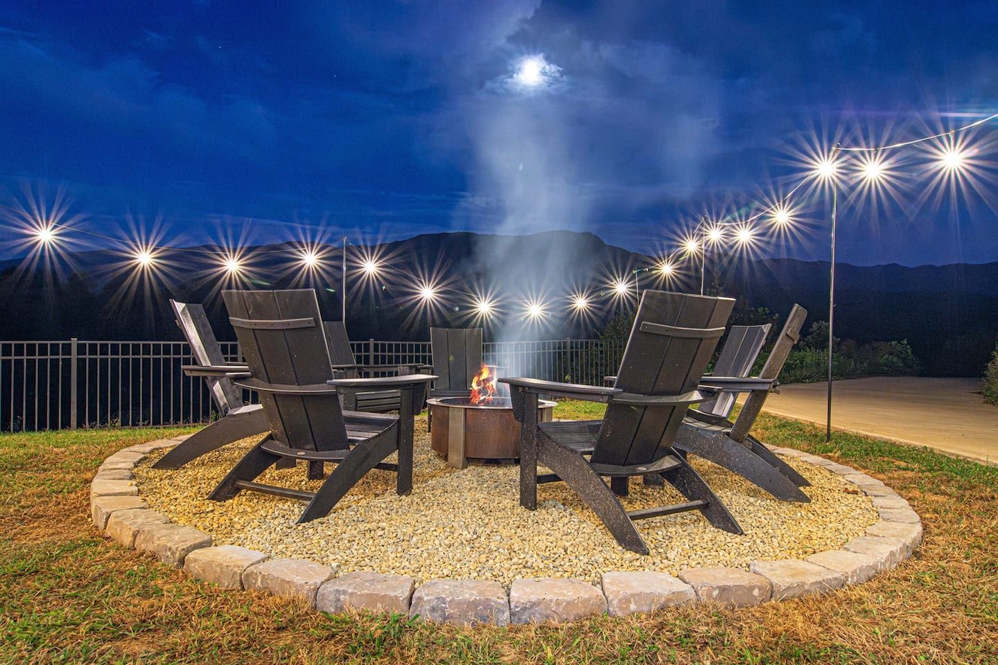 Under a blanket of stars in the vast mountain sky, the fire comes alive, casting a warm glow amid the serene backdrop. The lights create a magical setting that invites you to gather, share stories, and enjoy the peaceful beauty of the night.