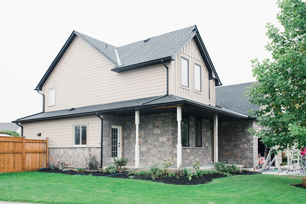 Two-storey home with new stone and lap siding by Southcote Construction