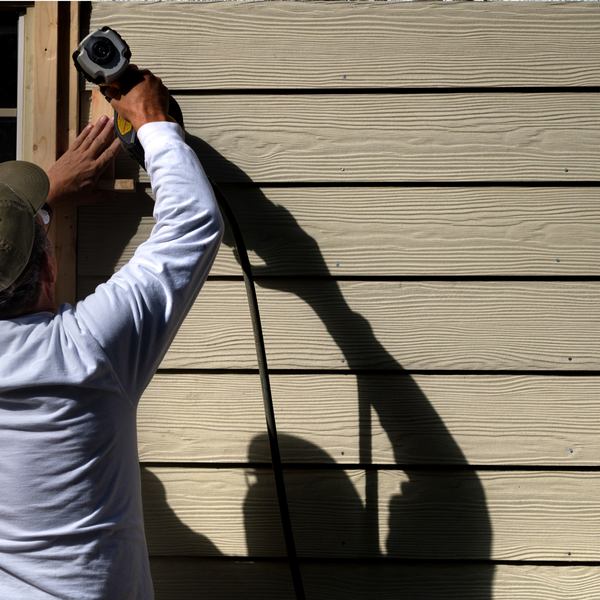 contractor inspecting siding and exterior protection
