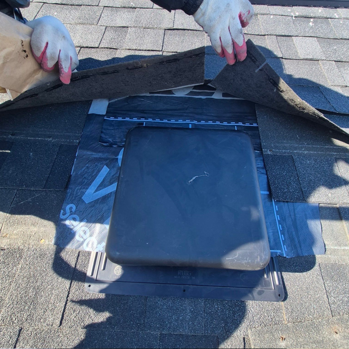 Roof ventilation and shingle inspection during a roofing evaluation in Winchester MA