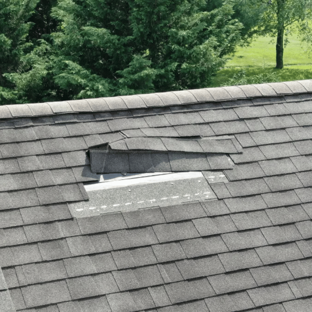 missing asphalt shingles on residential roof requiring repair in Greater Boston MA