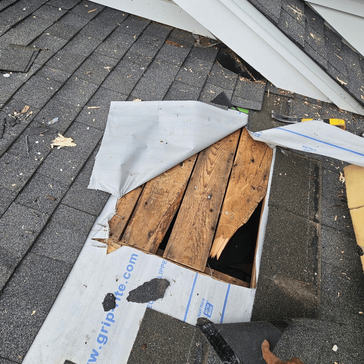 roof repair in progress showing damaged decking under asphalt shingles in Melrose MA