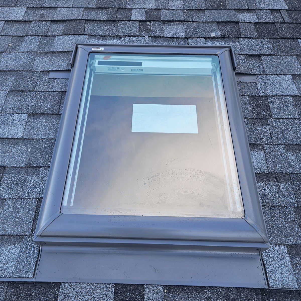 Roof skylight installation on asphalt shingles in Greater Boston home
