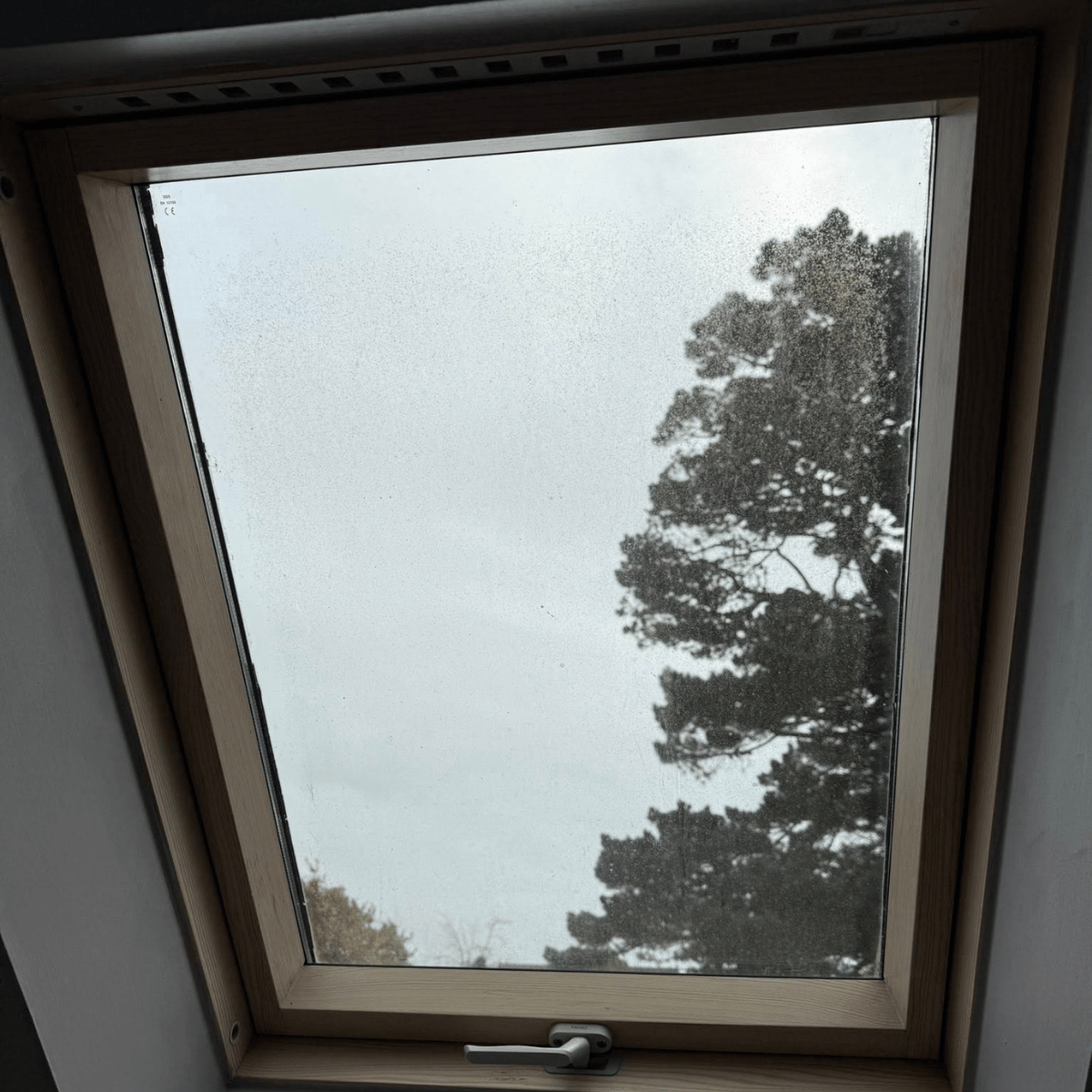 Skylight window view showing cloudy glass and potential seal failure in Massachusetts home