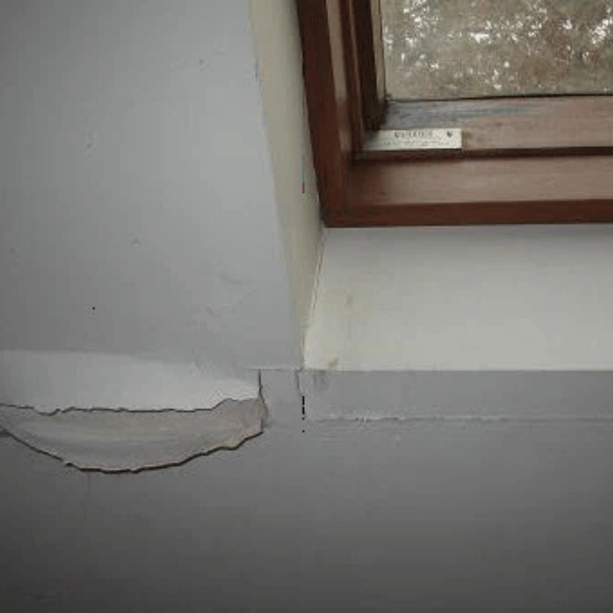 Cracked drywall near skylight from moisture damage and roof issues