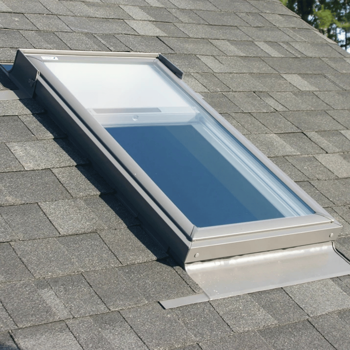 Fixed skylight installed on asphalt roof providing natural light without ventilation