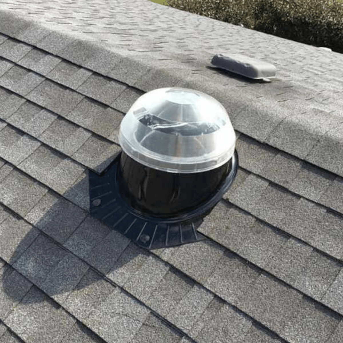 Solar tube skylight on asphalt roof for hallway lighting in Massachusetts