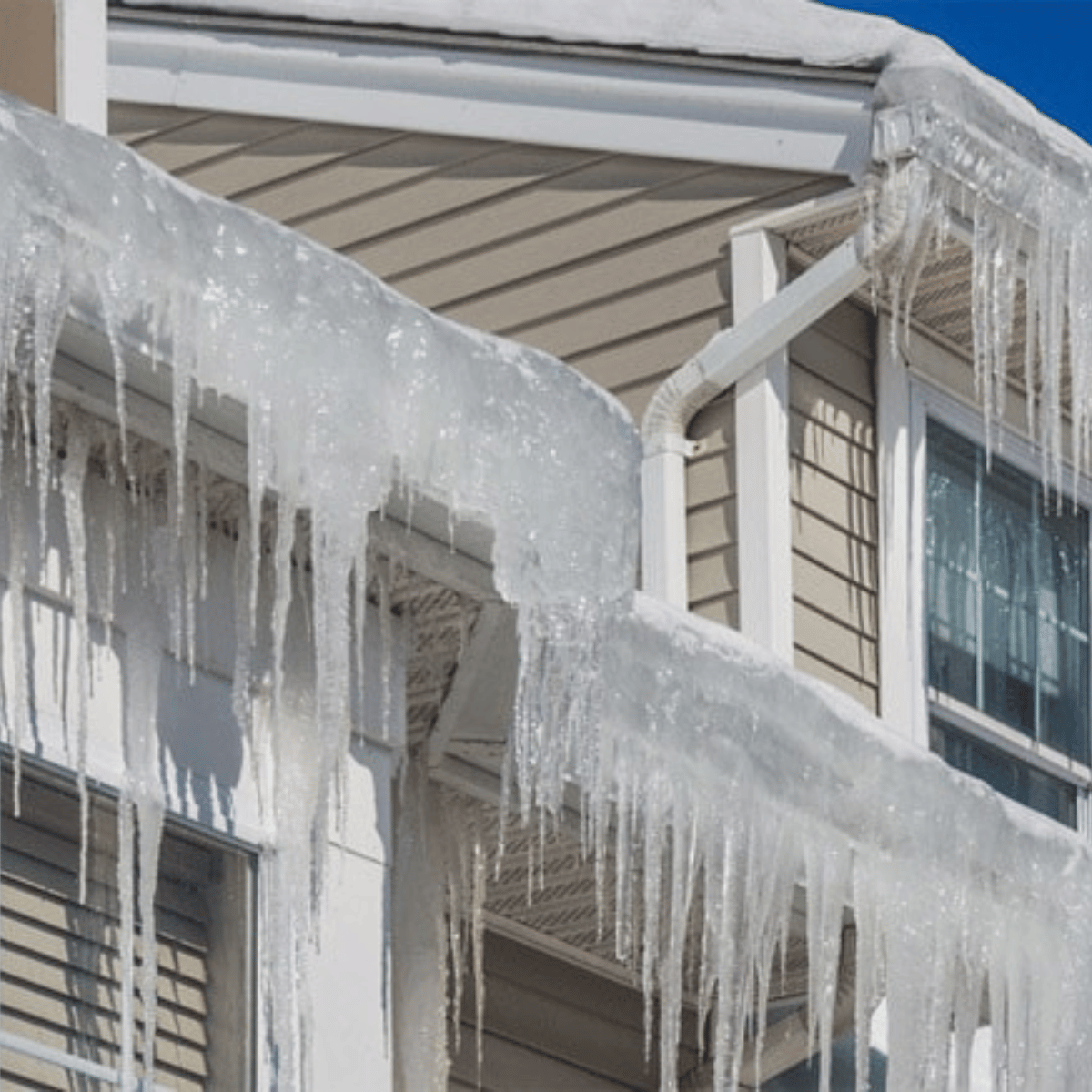 Large icicles along roof edge caused by possible ice dam buildup