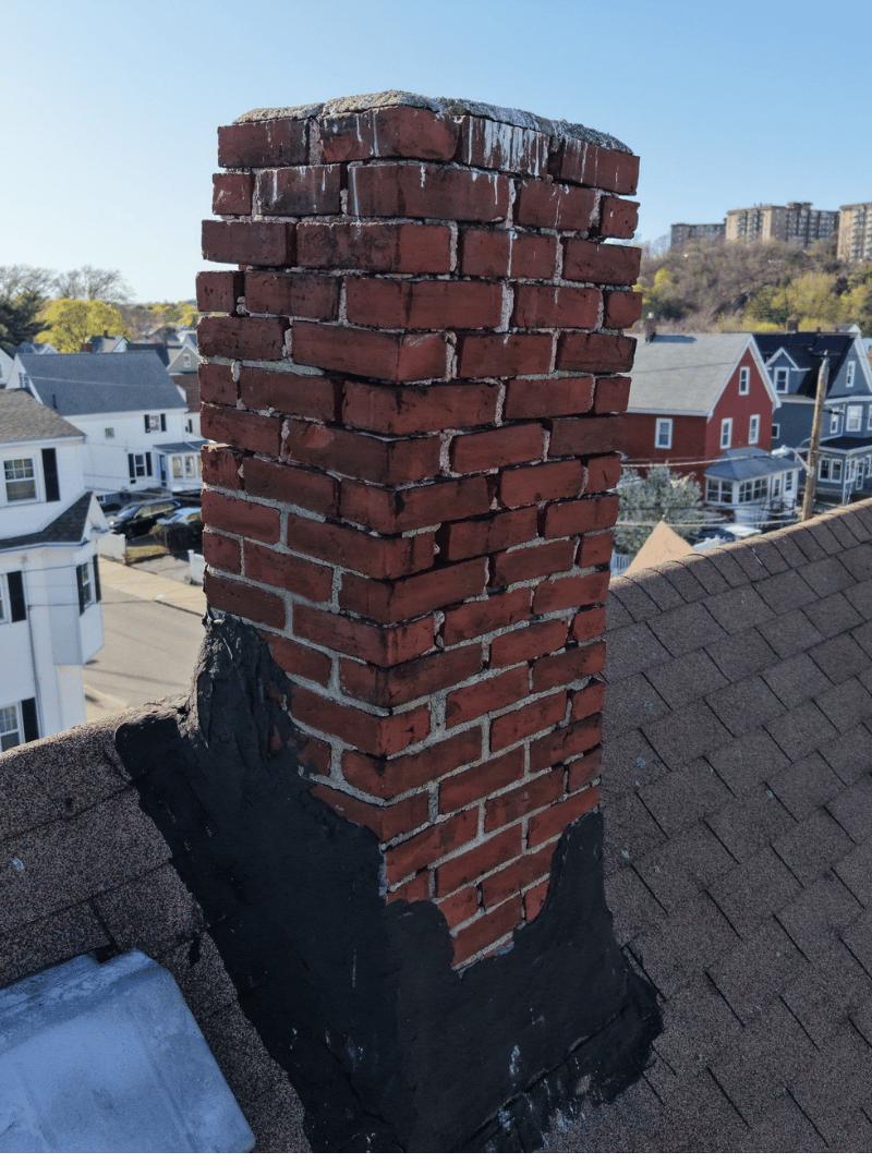 Roof replacement work in progress on historic brick home in Malden MA