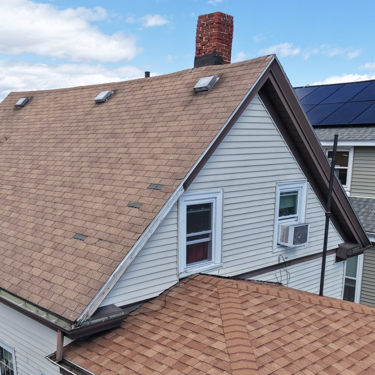 Roof replacement work in progress on historic brick home in Malden MA