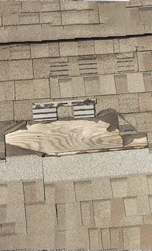 Missing roof shingles exposing underlayment during roof inspection