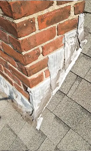 Chimney flashing issue found during a roof inspection in Massachusetts