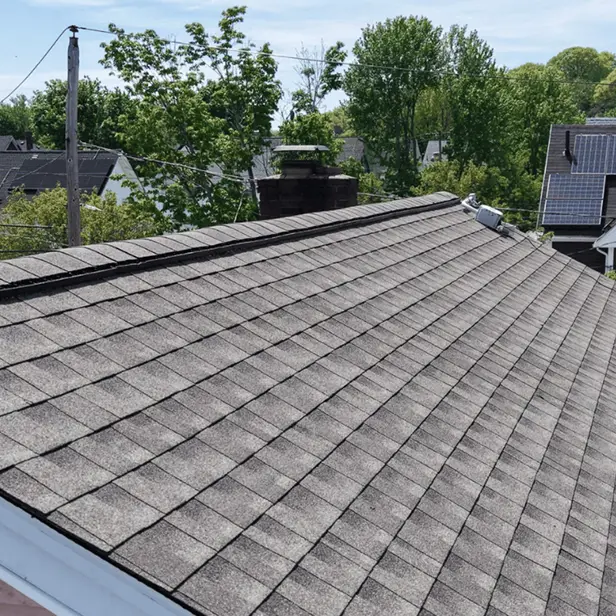 Roof replacement work in progress on historic brick home in Malden MA
