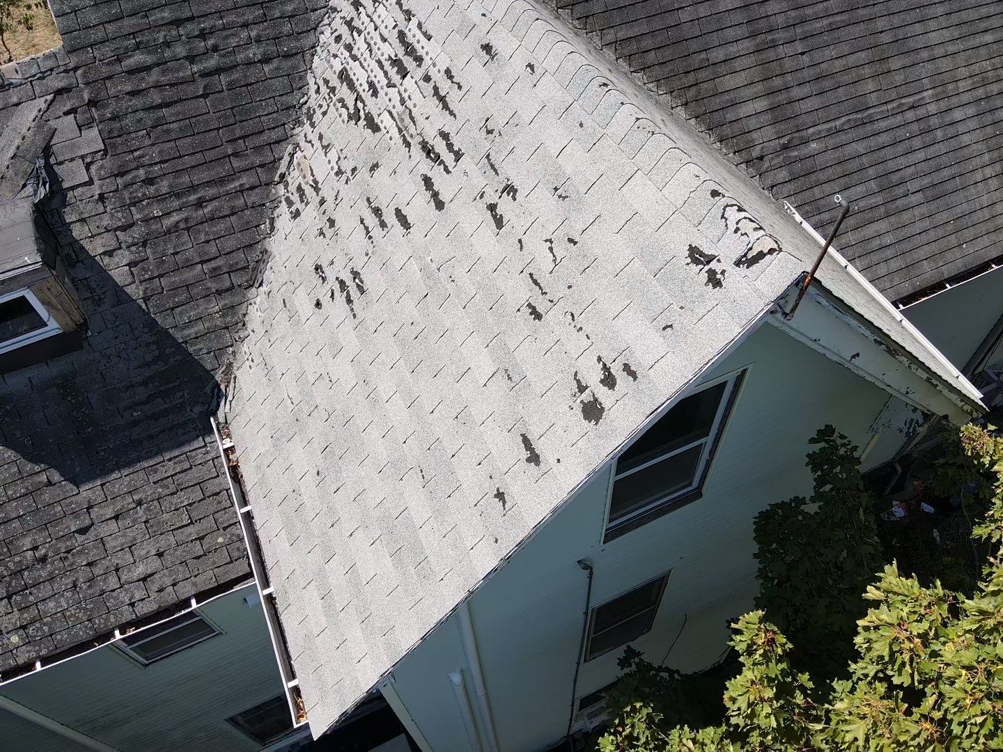 Asphalt shingle roof inspection showing vents chimney and roof valleys