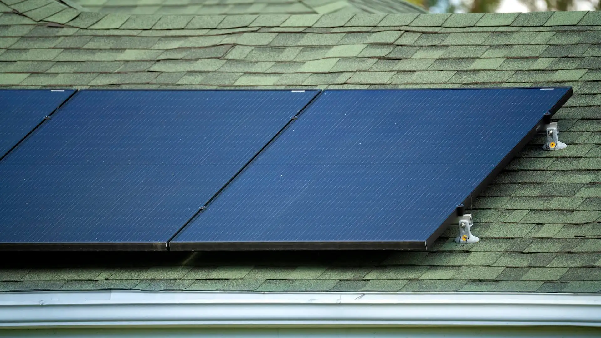 Residential roof with solar panels installed before a future roof replacement in Massachusetts.