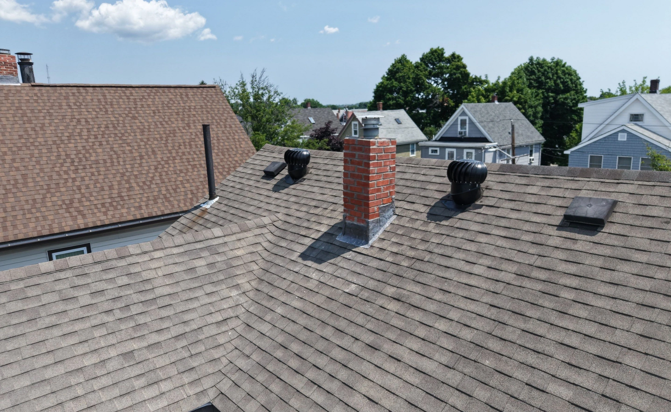 Targeted roof maintenance and chimney flashing repair on a historic home in Medford MA