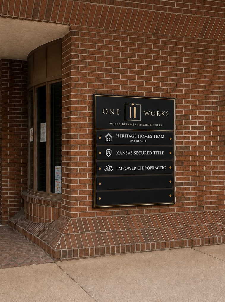 The One Eleven Works entrance sign on the brick exterior of 111 W. 8th St.