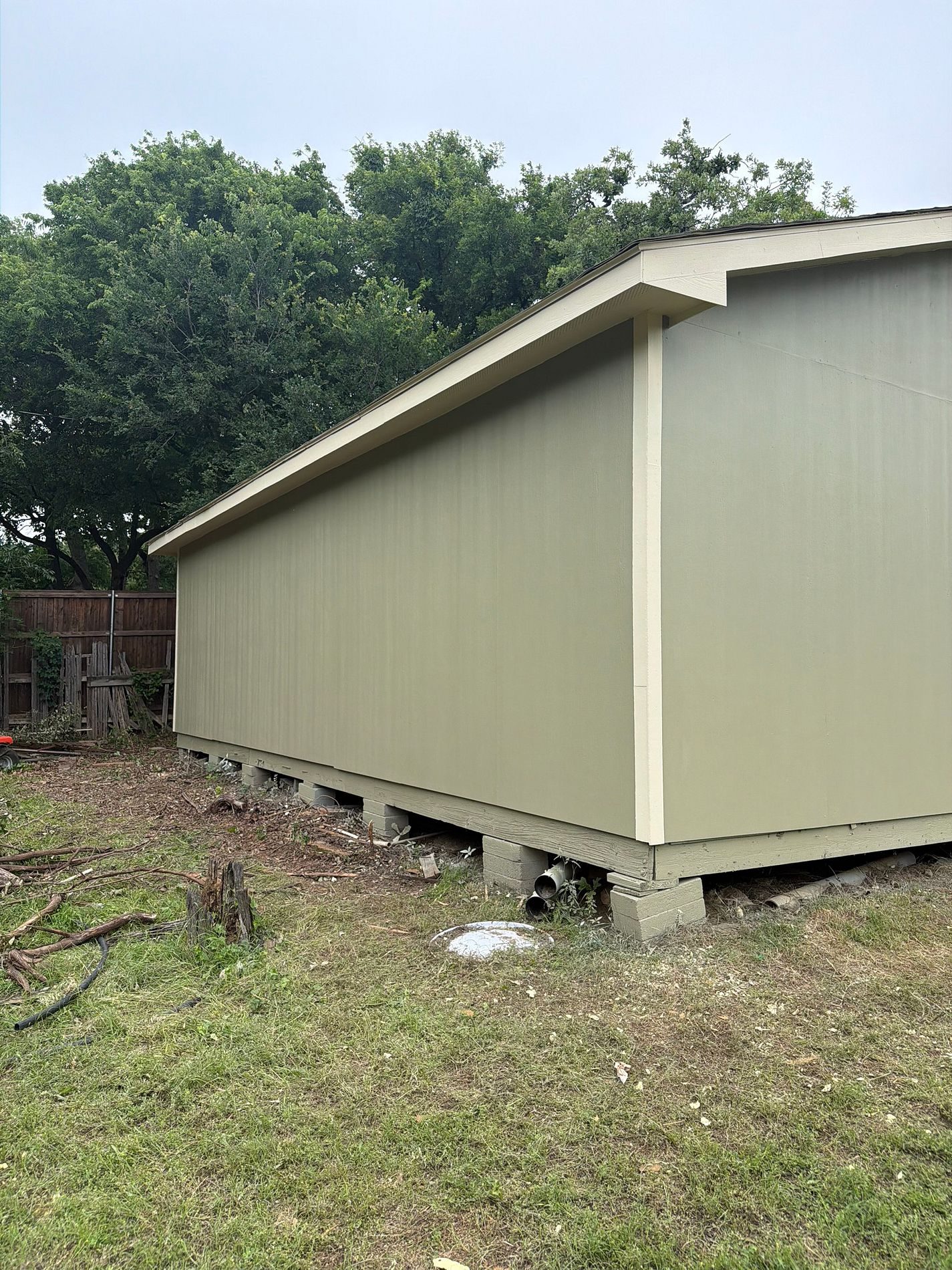 New olive green siding on a detached garage