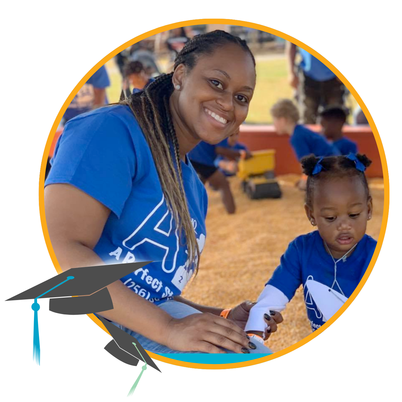 teacher and toddler smiling in sand pit