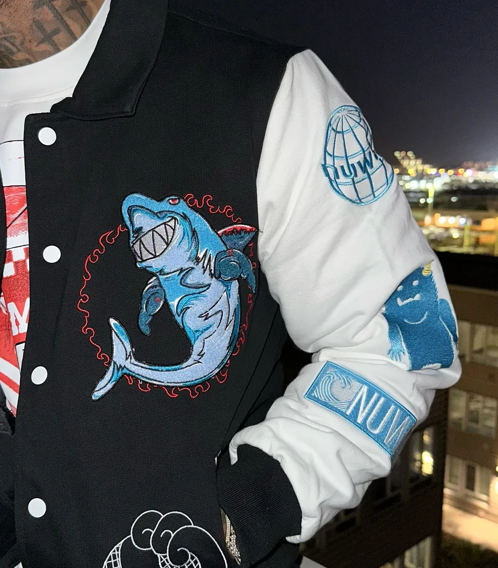 Close-up of the chenille shark patch and sleeve embroidery at night