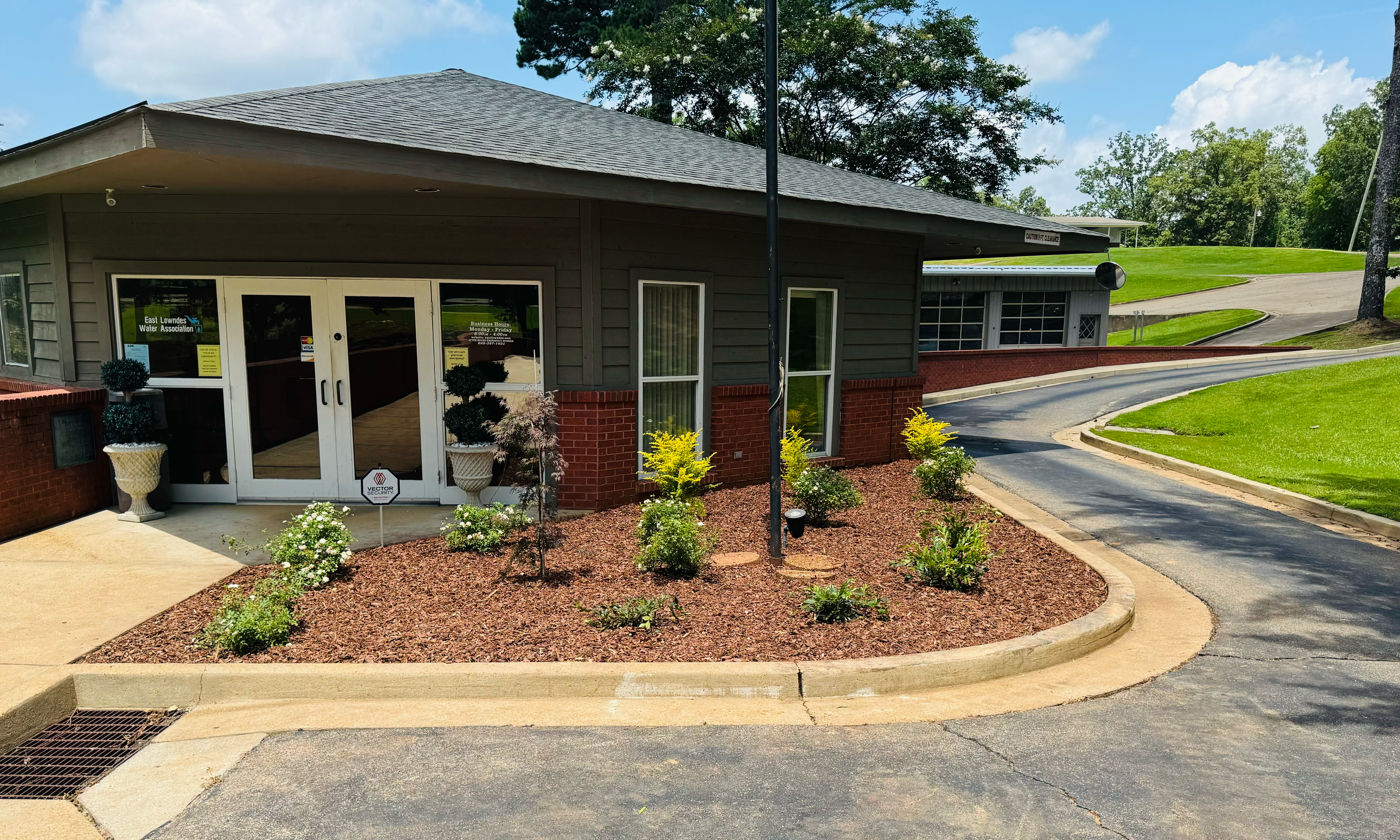 Commercial property landscaping featuring fresh sod and trimmed bushes in Columbus, MS