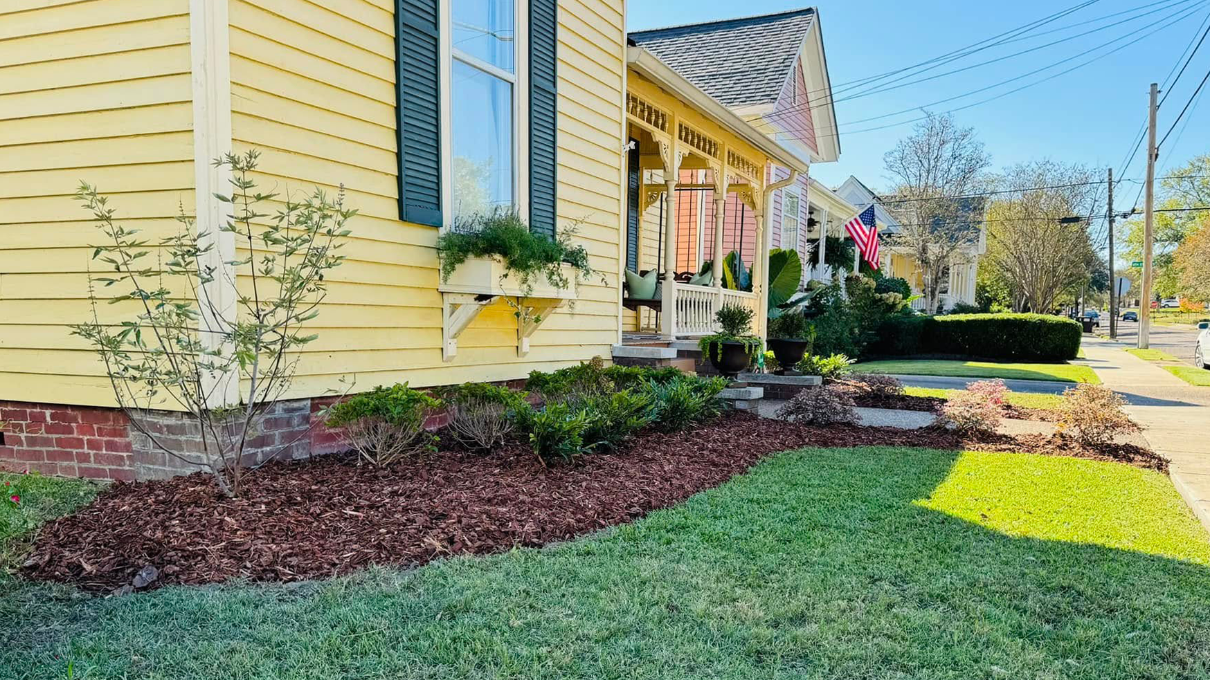 Technician edging a well-manicured lawn in a Columbus home
