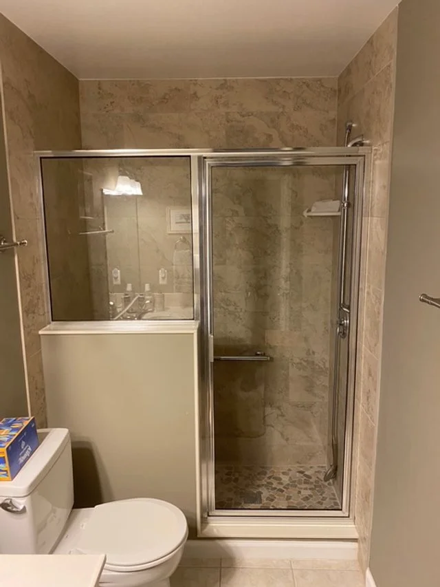 Framed 2-piece shower attached to knee wall