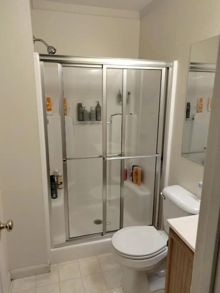 Framed sliding glass shower door