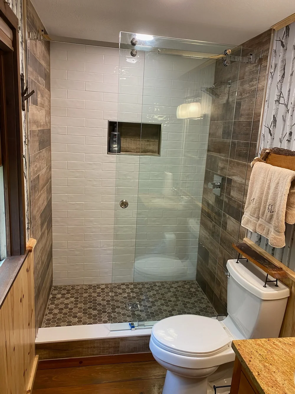 Barn door style sliding glass shower door