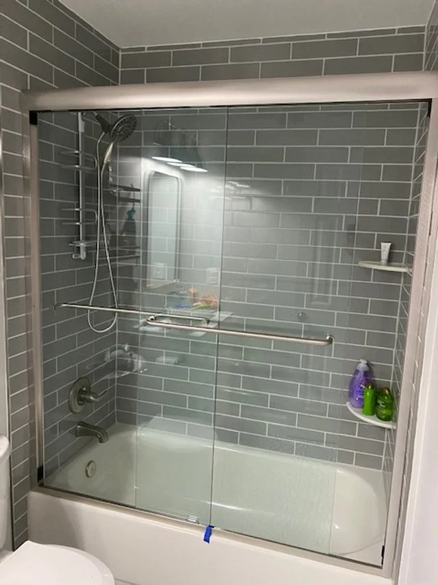 Sliding glass tub door
