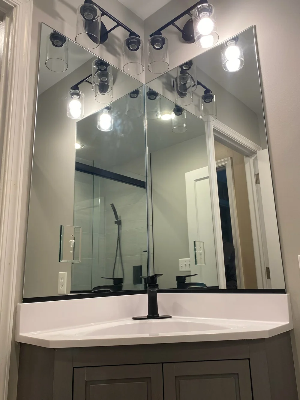 Two bathroom mirrors at an angle