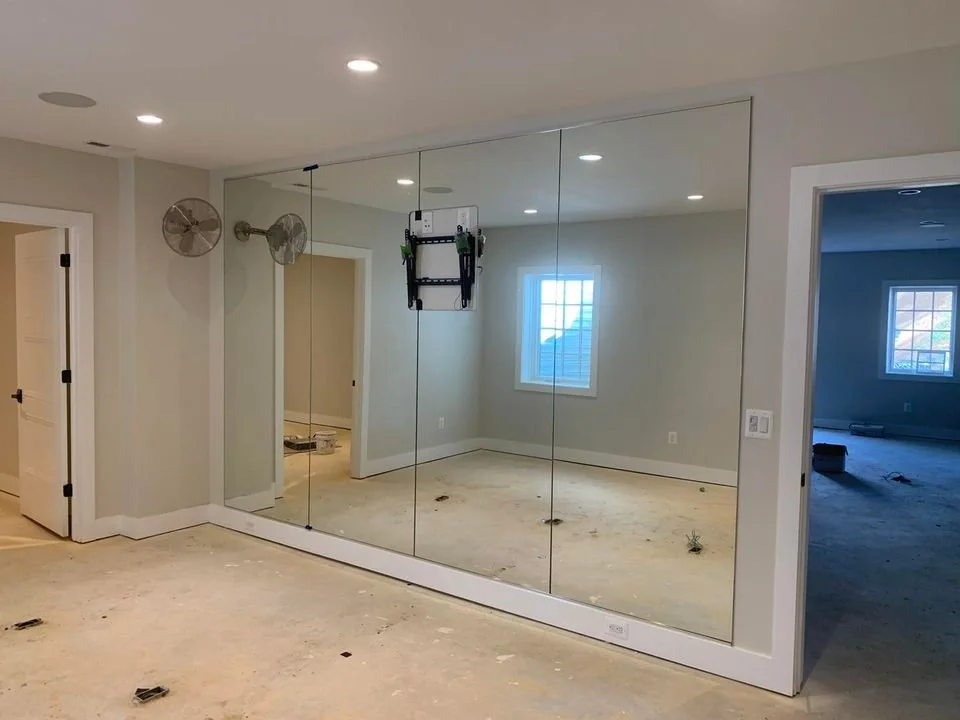Exercise room mirrors with cutout for TV mount