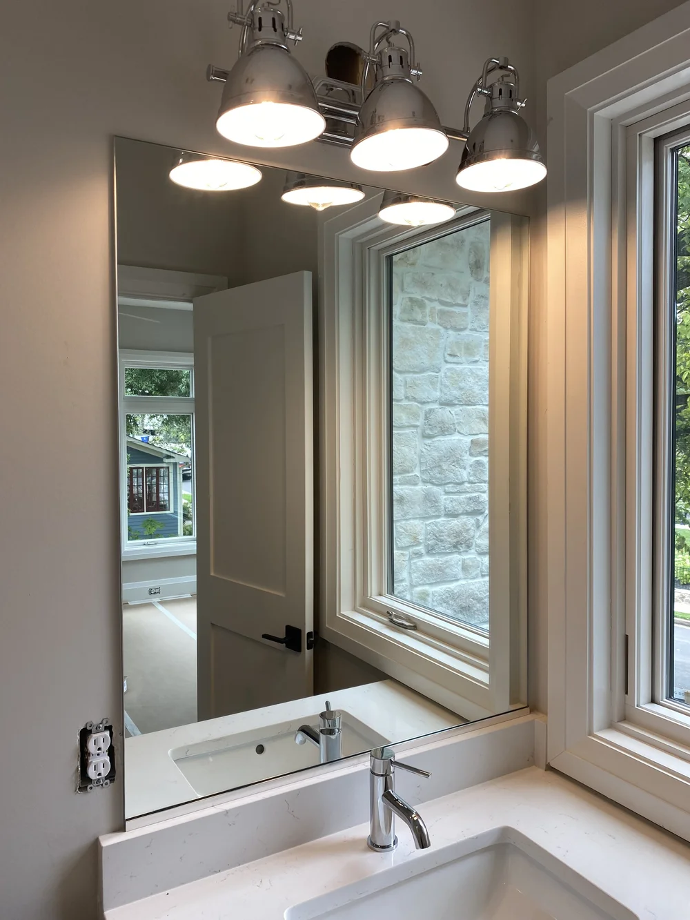 Bathroom mirror on vanity with Brushed Nickel hardware