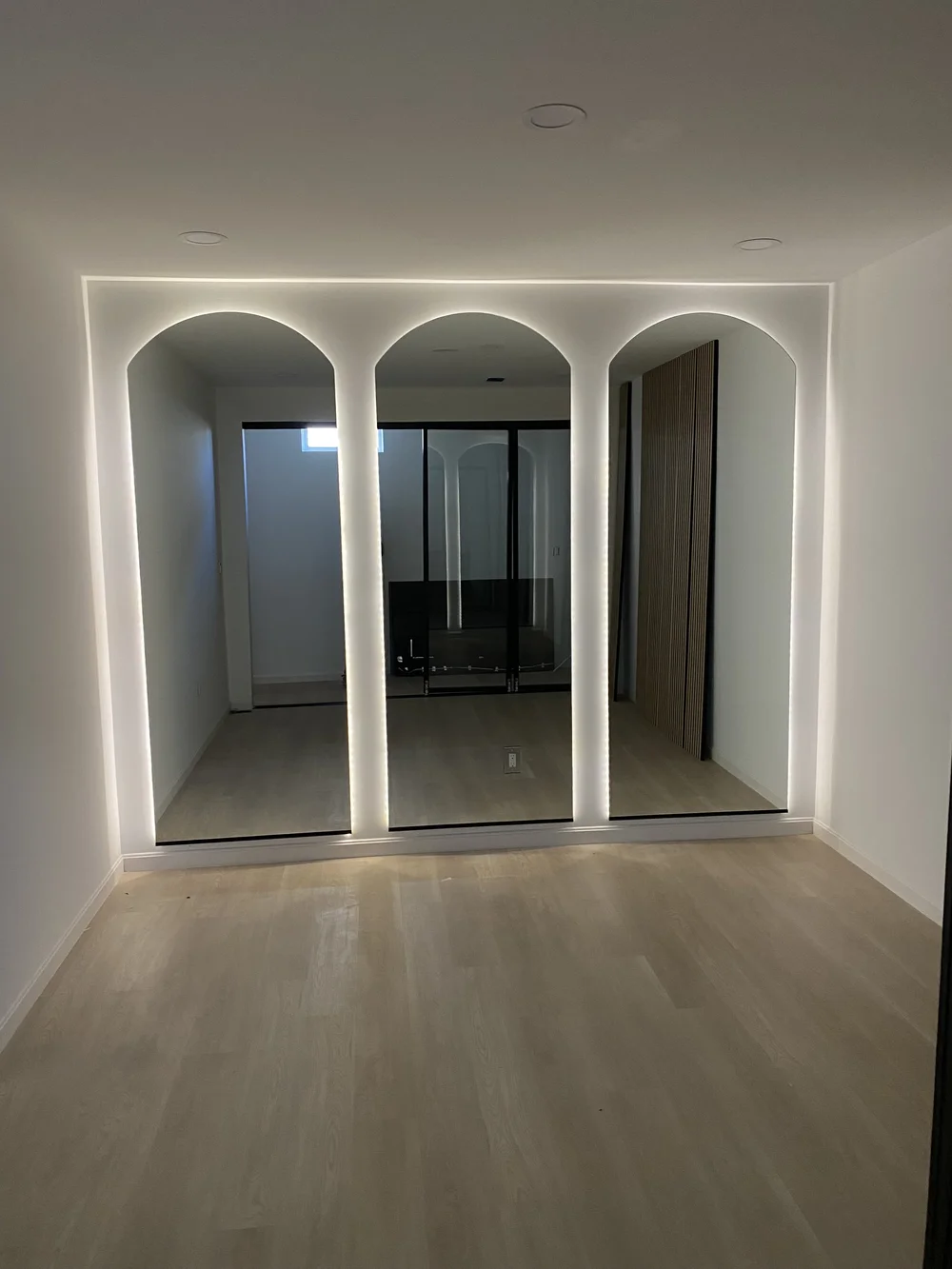 Three specialty-cut mirrors on a wall