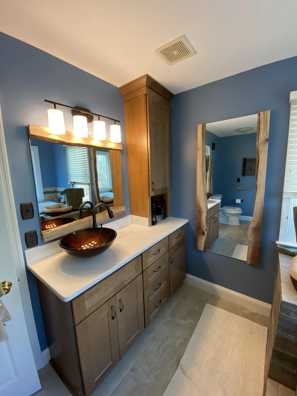 Two bathroom mirrors with custom wood trim