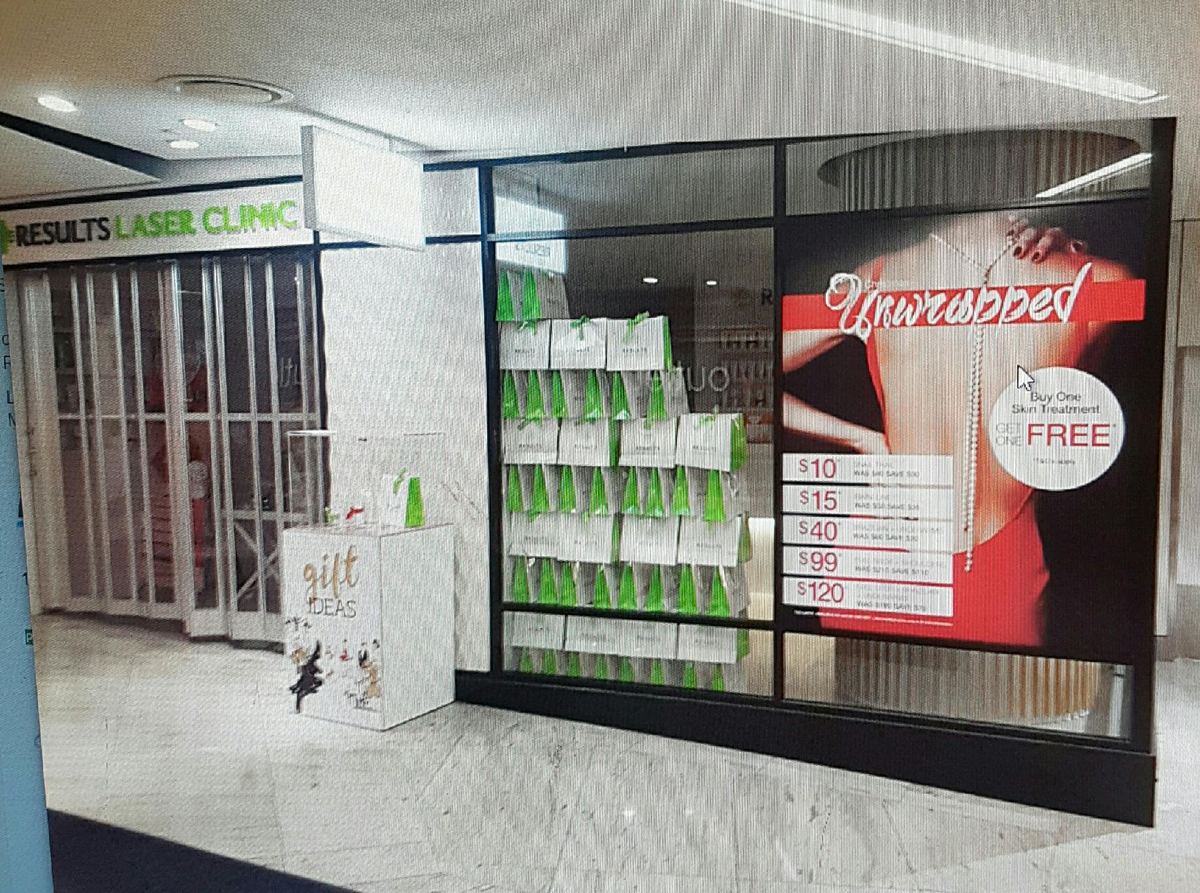 Results Laser Clinic store front with campaign window graphics and gift display