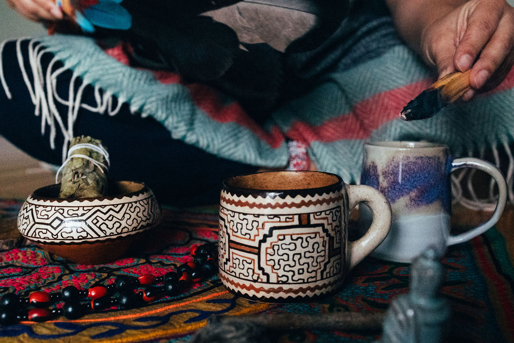 Cup of ceremonial cacao on an embroidered altar cloth at a St. Louis cacao ceremony