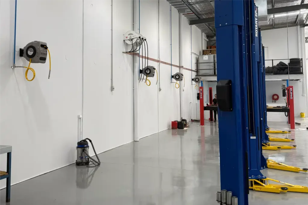 Aluminium droppers and outlets on a workshop wall