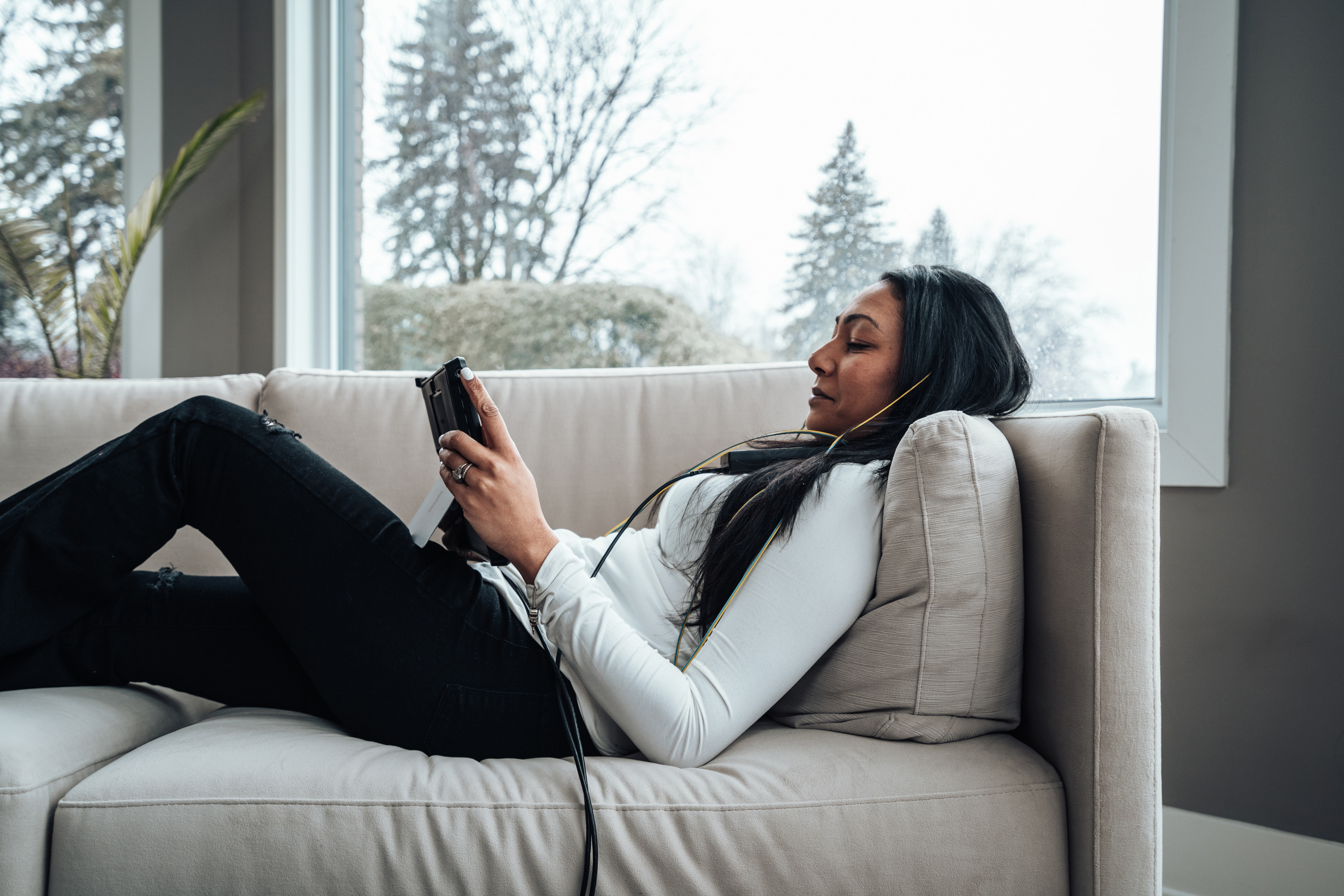 Woman relaxing comfortably during a neurofeedback brain training session