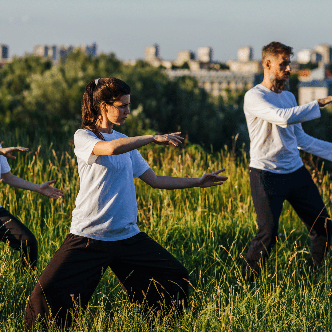 practicing Tai Chi in field