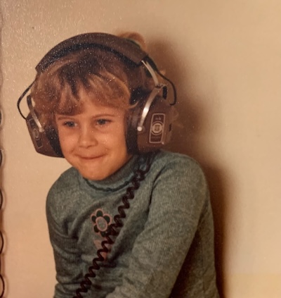 Young Wendi wearing oversized headphones, 1978