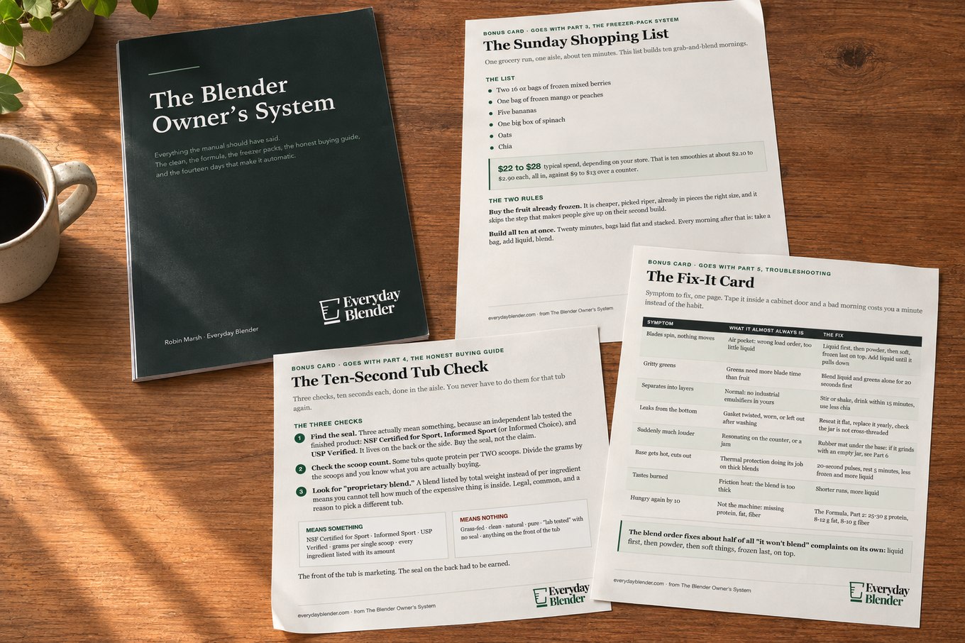 The Blender Owner's System guide with its three bonus cards laid out on a kitchen table