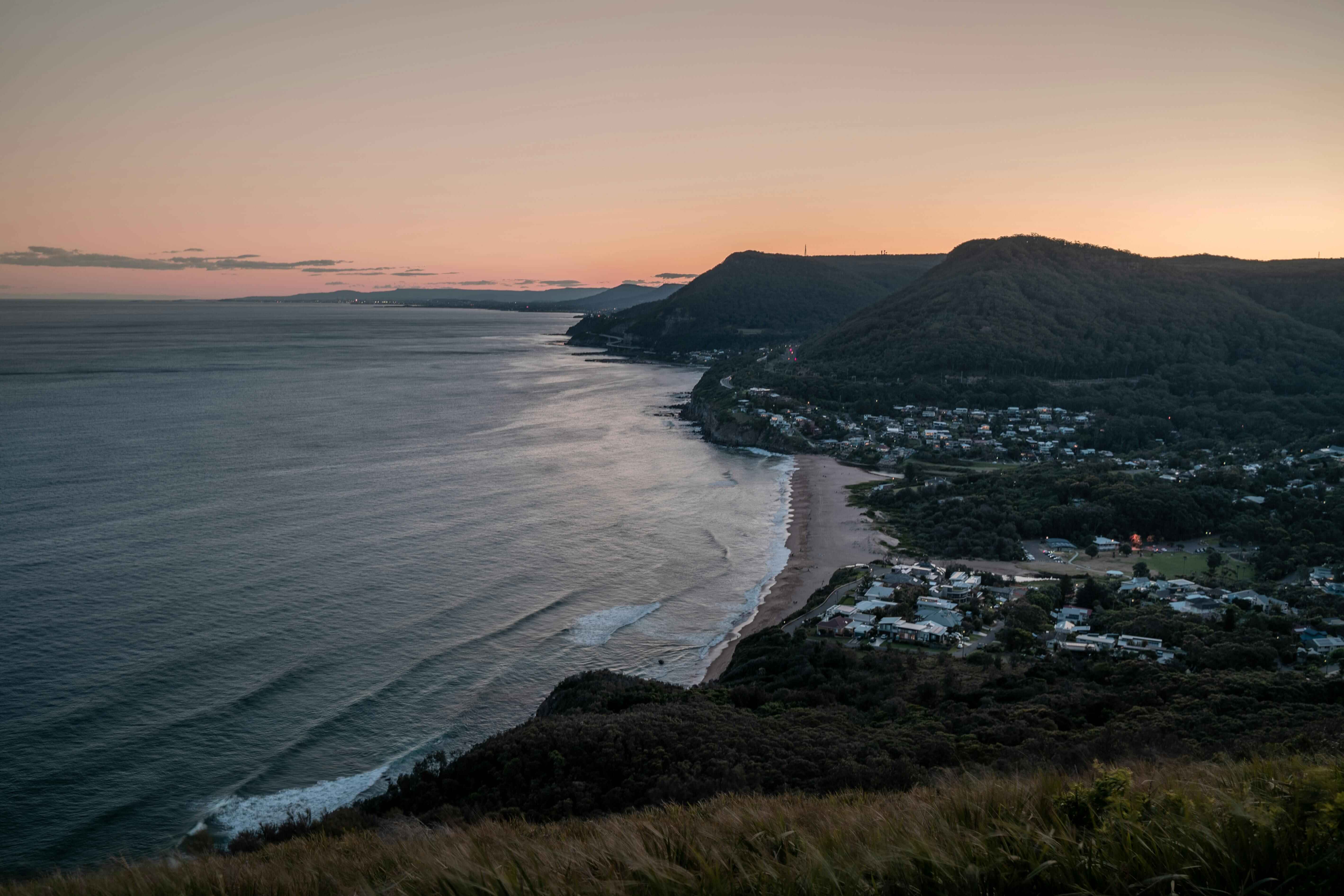 Sunset view over Wollongong's Illawarra escarpment and coastal suburbs, showcasing the best suburbs in Wollongong's property market for first home buyers in 2026.