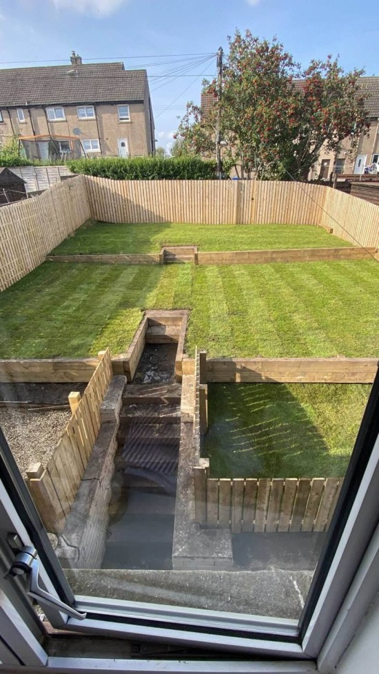 Completed garden landscaping with lawn and timber fencing