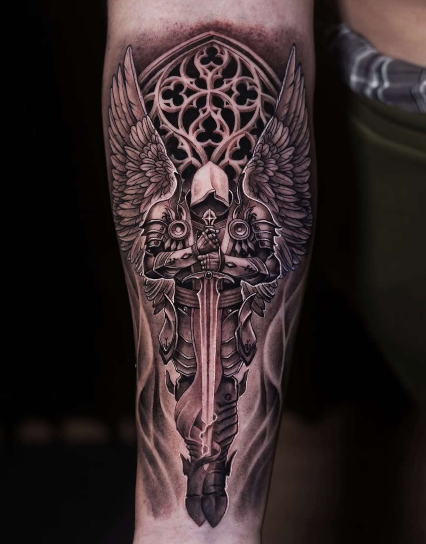 Black and grey arm tattoo by a Love Gun artist